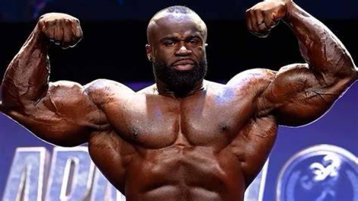 330lb Samson Dauda Towers Over Influencer Sam Sulek While Posing Side