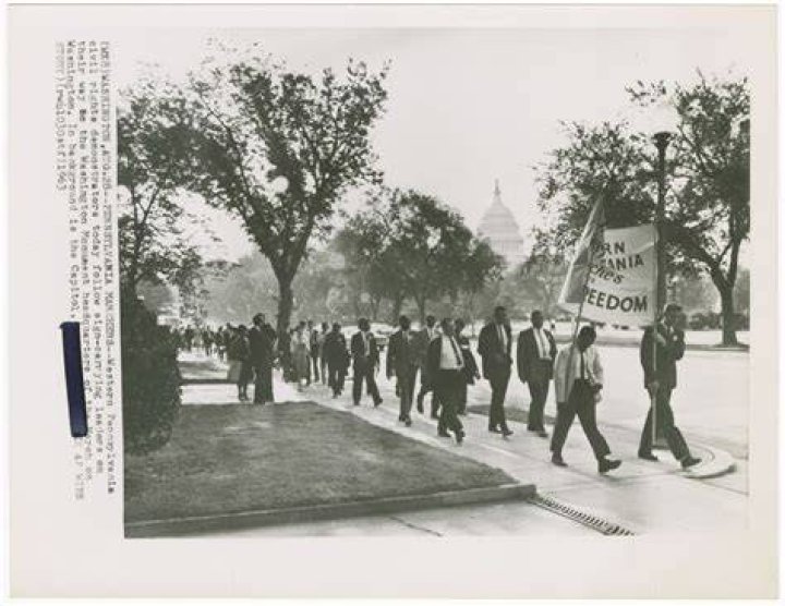 Demonstrators march to entrance of KKK national director Thomas Robb's