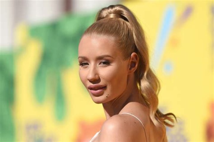 Iggy Azalea makes a rare appearance with clothes on in stylish red