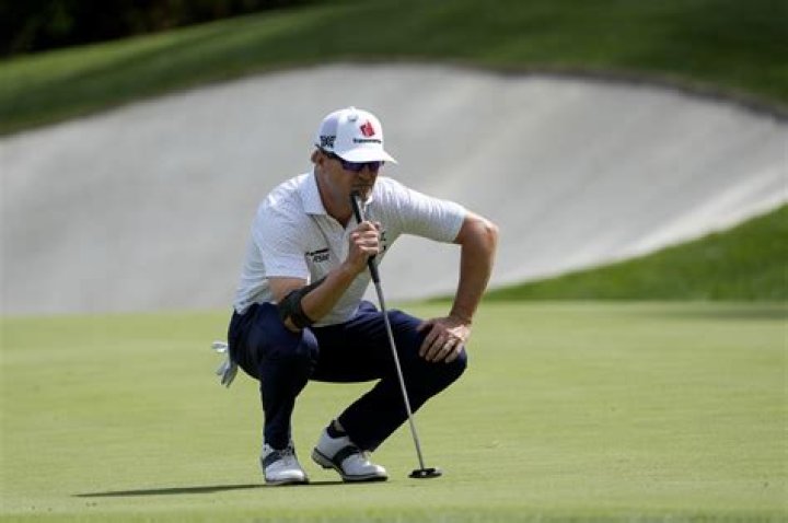 Masters champion Zach Johnson hits his tee shot on hole No. 2 during